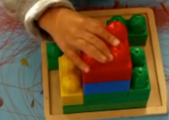 hand and lego brick